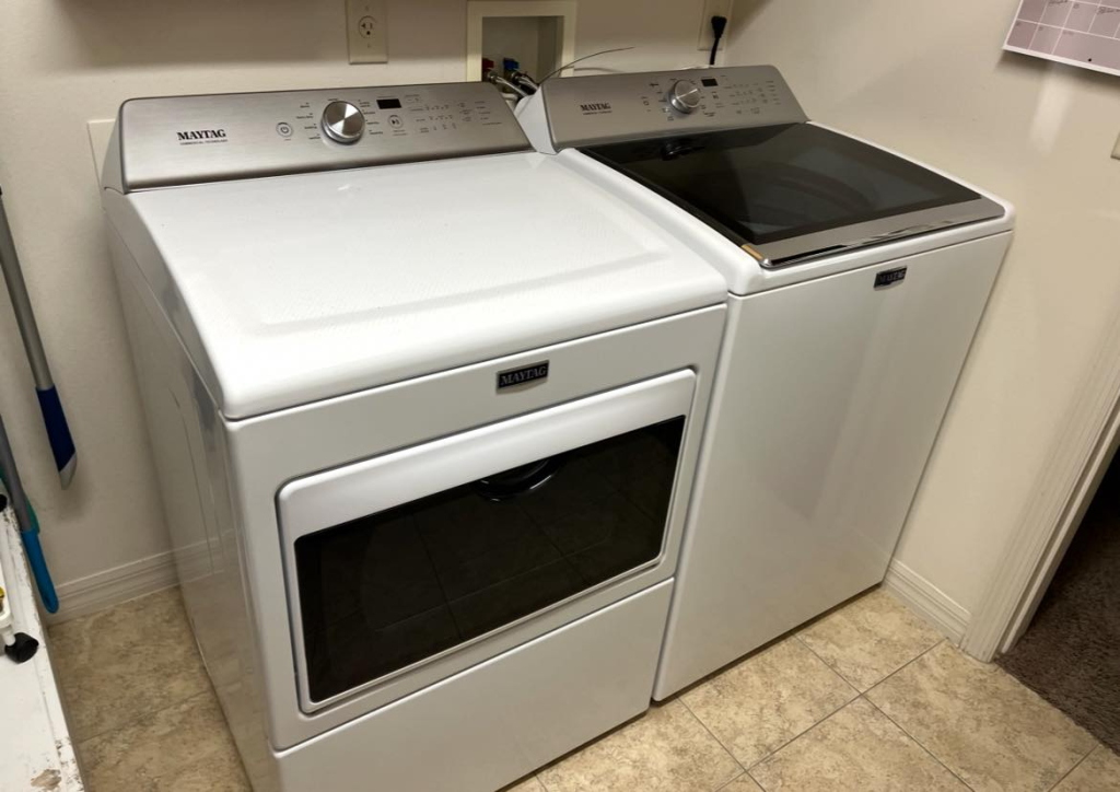 Clean washer and dryer in laundry room after vent cleaning