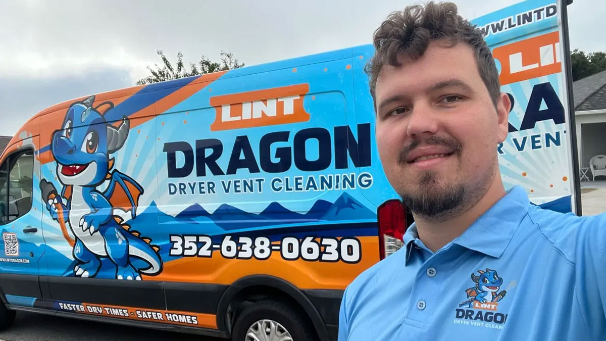 Jonathan, owner of lint dragon standing next to company vehicle