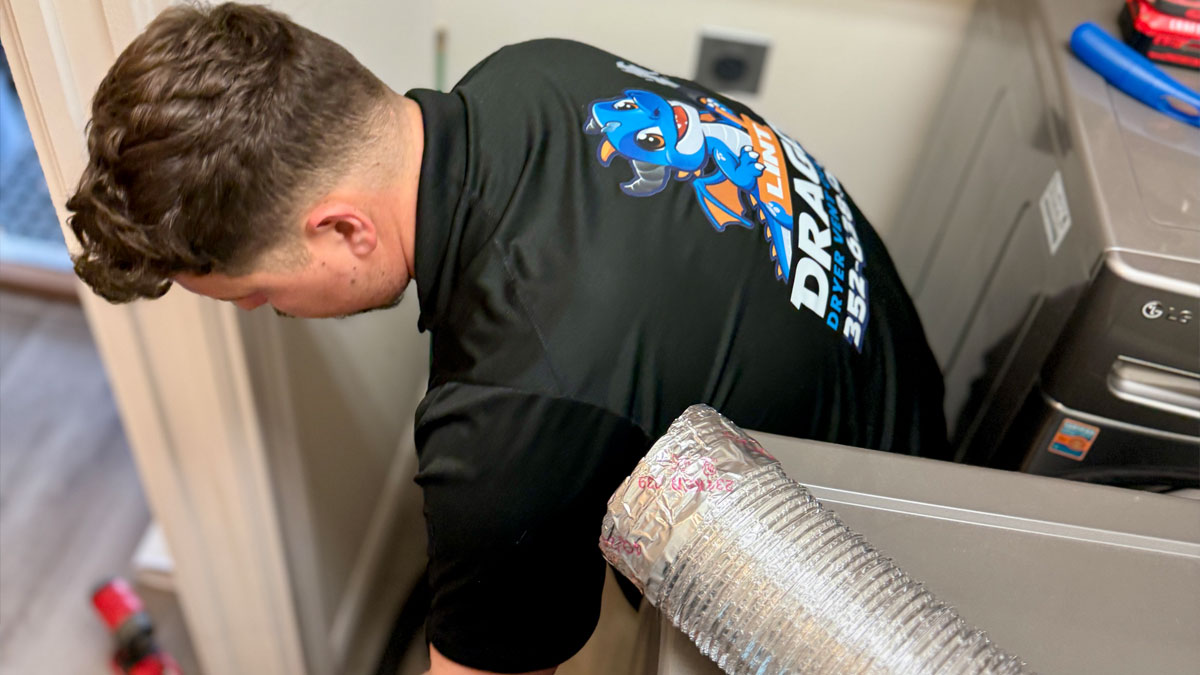 Jonathan from Lint Dragon performing a dryer vent cleaning in the villages