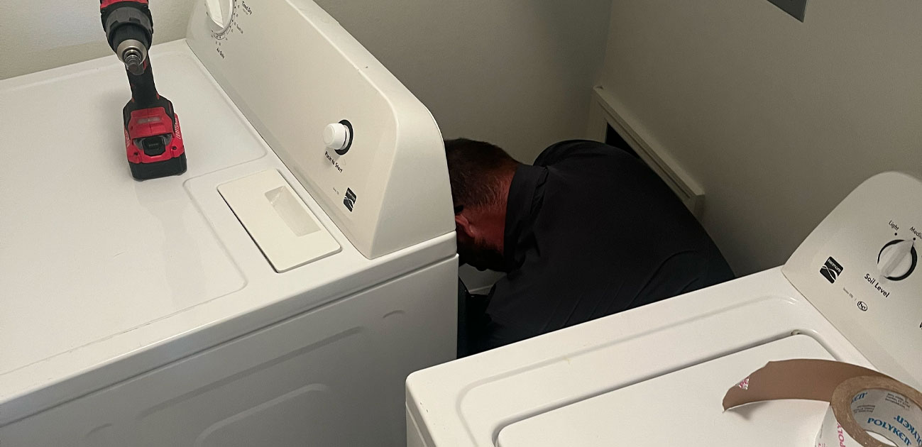 Dryer being serviced by professional dryer vent technician