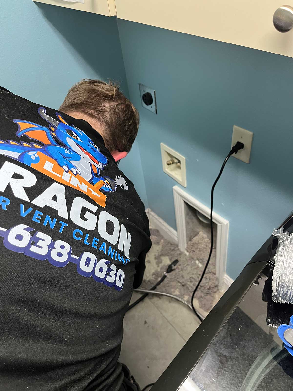 clogged dryer vent being cleaned